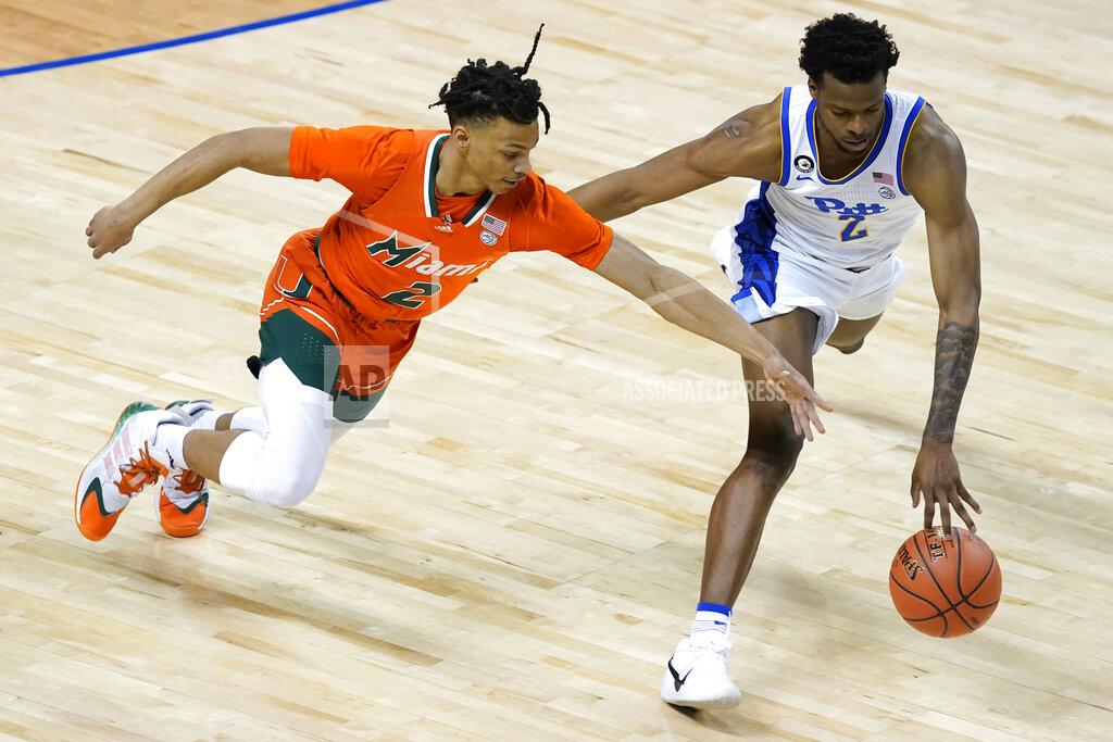 Gerry Broome Miami guard Isaiah Wong (2) chases a ball with Pittsburgh guard Femi Odukale (2) during the first half an NCAA college basketball game in the first round of the Atlantic Coast Conference tournament in Greensboro, N.C., Tuesday, March 9, 2021. (AP Photo/Gerry Broome)