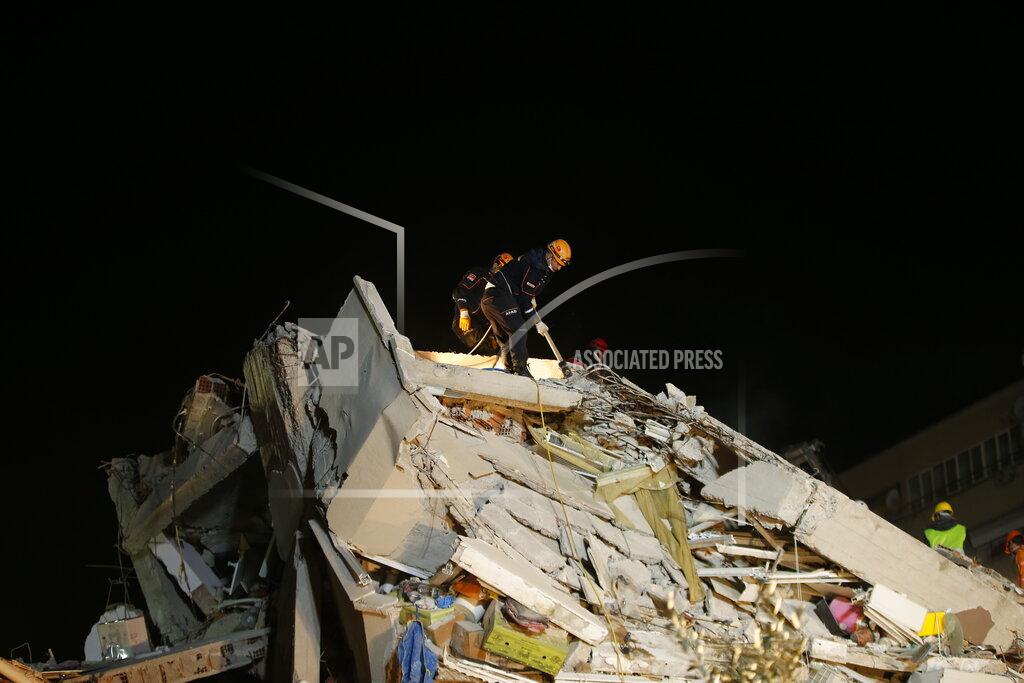 Emrah Gurel Members of rescue services search in the debris of a collapsed building for survivors in Izmir, Turkey, early Saturday, Oct. 31, 2020. A strong earthquake struck Friday in the Aegean Sea between the Turkish coast and the Greek island of Samos, killing several people and injuring hundreds amid collapsed buildings and flooding. (AP Photo/Emrah Gurel)