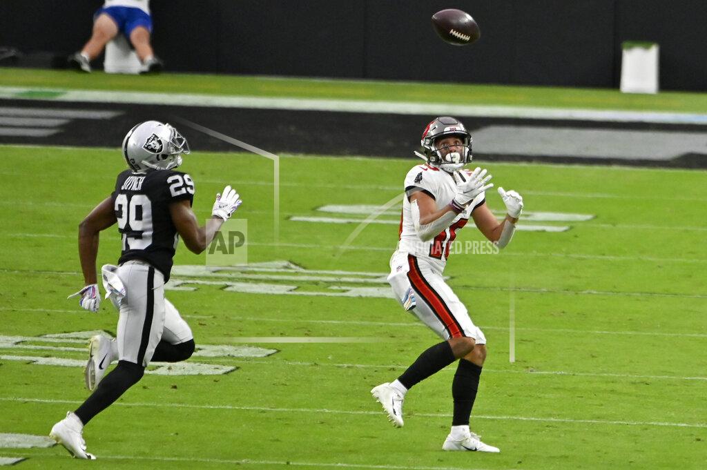 David Becker Tampa Bay Buccaneers wide receiver Scott Miller (10) makes a catch over Las Vegas Raiders free safety Lamarcus Joyner (29) during the second half of an NFL football game, Sunday, Oct. 25, 2020, in Las Vegas. (AP Photo/David Becker)