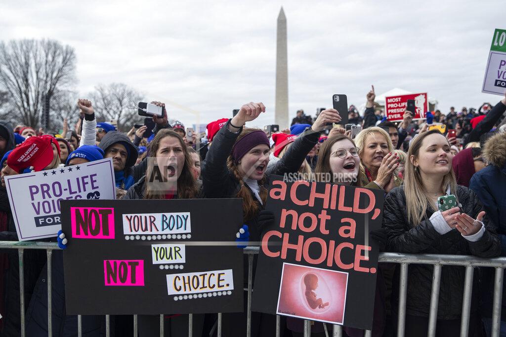 Evan Vucci FILE - In this Jan. 24, 2020, file photo, supporters cheer as President Donald Trump speaks during the annual "March for Life" rally on the National Mall, in Washington. Anti-abortion leaders across America were elated a year ago when Donald Trump became the first sitting U.S. president to appear in person at their highest-profile annual event, the March for Life held every January. The mood is more sober now — a mix of disappointment over Trump’s defeat and hope that his legacy of judicial appointments will lead to future court victories limiting abortion rights. (AP Photo/ Evan Vucci, File)