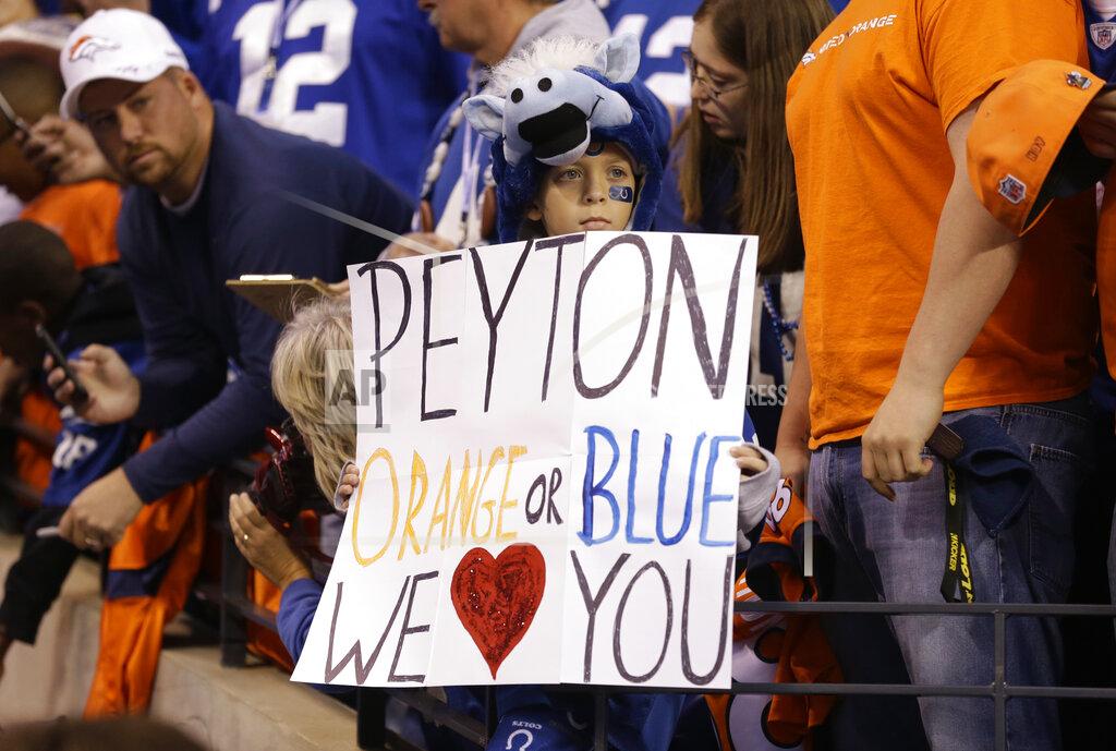 Michael Conroy FILE - An Indianapolis Colts fan holds a sign showing support for Denver Broncos quarterback Peyton Manning before an NFL football game between the Indianapolis Colts and the Broncos in Indianapolis, in this Sunday, Oct. 20, 2013, file photo. After five straight victories to open the season with his new team, the Broncos, Manning was on his way to his record fifth MVP award while setting all sorts of league passing marks. The matchup with the Colts in Indianapolis was ballyhooed like the second coming, but despite Manning's brilliance _ three touchdown passes, 386 yards in the air _ his replacement, Andrew Luck, got the win 39-33. “I am kind of relieved in some ways that this game is over,” he said at the end of a long night. (AP Photo/Michael Conroy, File)