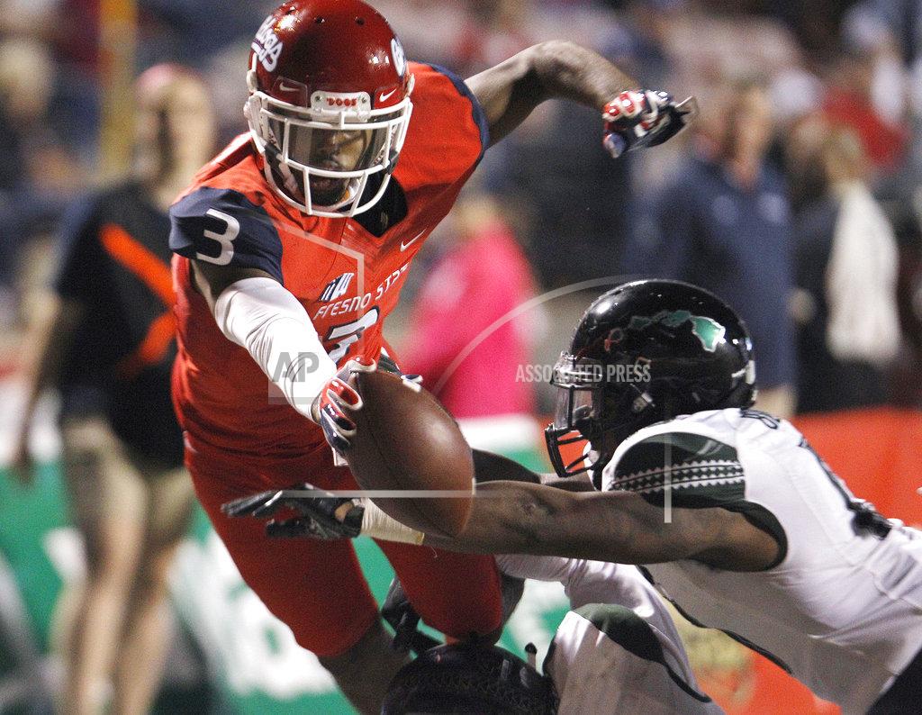 Gary Kazanjian Fresno State wide receiver KeeSean Johnson tries to leap over the goal line against a Hawaii defender during the second half of an NCAA college football game in Fresno, Calif., Saturday, Oct. 27, 2018. Fresno State won 50-20. (AP Photo/Gary Kazanjian)