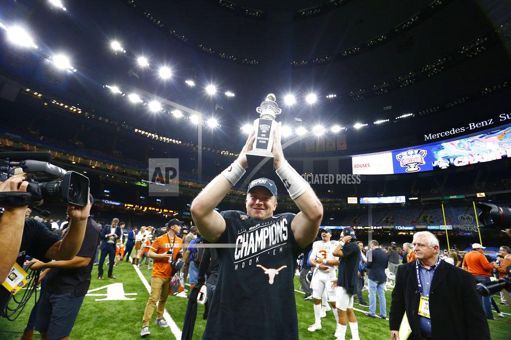 Butch Dill Texas quarterback Sam Ehlinger holds up his MVP trophy after Texas defeated Georgia 28-21 in the Sugar Bowl NCAA college football game in New Orleans, Tuesday, Jan. 1, 2019. (AP Photo/Butch Dill)