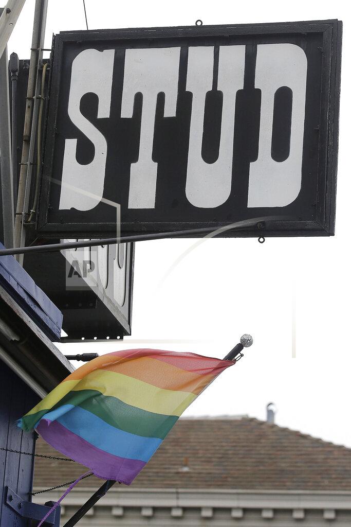 Jeff Chiu FILE - This July 6, 2016, file photo shows a rainbow flag flying under a sign for The Stud bar in San Francisco. The Stud, one of the nation's most celebrated gay bars, is being forced from its home amid the financial fallout of the coronavirus pandemic. (AP Photo/Jeff Chiu, File)