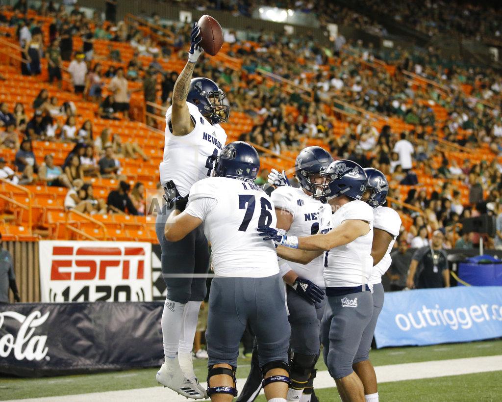 Marco Garcia Nevada wide receiver Elijah Cooks (4) celebrates with teammates after making a touchdown against Hawaii during the first half of an NCAA college football game Saturday, Oct. 20, 2018, in Honolulu. (AP Photo/Marco Garcia)