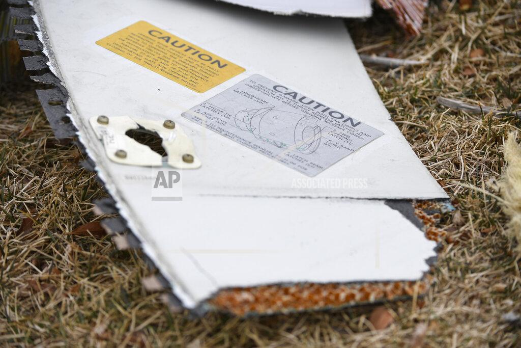 Andy Cross A piece of an airplane engine is seen in the median along Sheridan Boulevard near E. 13th Avenue, Saturday, Feb. 20, 2021, in Broomfield, Colo. Debris from a United Airlines plane fell onto Denver suburbs during an emergency landing Saturday after one of its engines suffered a catastrophic failure and rained pieces of the engine casing on a neighborhood where it narrowly missed a home. (Andy Cross/The Denver Post via AP)