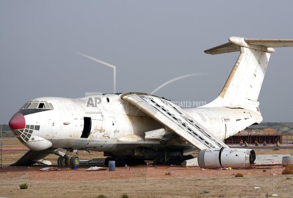 Kamran Jebreili An abandoned plane, Ilyushin Il-76, once tied to arms smuggler Viktor Bout, is being dismantled at the old airfield of Umm al-Quwain, United Arab Emirates, Friday, May 27, 2022. The hulking, Soviet-era cargo plane has sat for decades under the blazing sun in this least-populated corner of the United Arab Emirates, its four jet engines silent after years in the employ of a Russian gunrunner infamously known as the "Merchant of Death." (AP Photo/Kamran Jebreili)