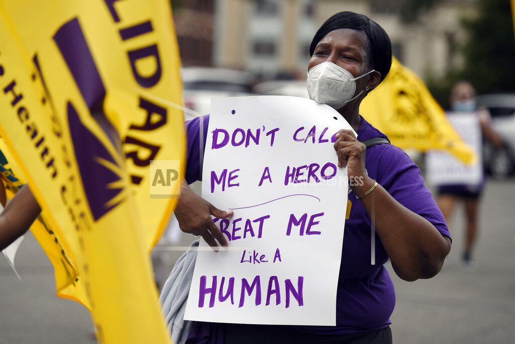 Jessica Hill FILE - Clarissa Johnson of Hartford marches with long-term care members of the New England Health Care Employees Union, during a rally to demand new laws to protect long-term caregivers and consumers, July 23, 2020, at the State Capitol in Hartford, Conn. Connecticut essential state employees, who worked long hours during the COVID-19 pandemic, are still waiting for "hero pay" from $22.5 million in federal pandemic funds set aside in the state budget. (AP Photo/Jessica Hill, File)