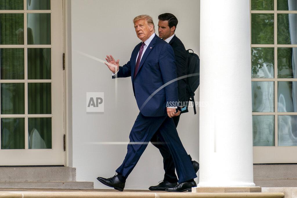 Andrew Harnik President Donald Trump, center, and director of the Presidential Personnel Office John McEntee, right, walk towards the Oval Office of the White House in Washington, Friday, Sept. 11, 2020, after returning from the Flight 93 National Memorial in Shanksville, Pa. (AP Photo/Andrew Harnik)