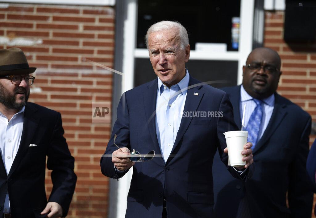Democratic presidential hopeful Joe Biden, center, leaves Food for the Soul restaurant with South Carolina Democratic Party Chairman Trav Robertson, left, and state director Kendall Corley, right, after filing paperwork for the South Carolina primary on Friday, Nov. 22, 2019, in Abbeville, S.C. (AP Photo/Meg Kinnard)