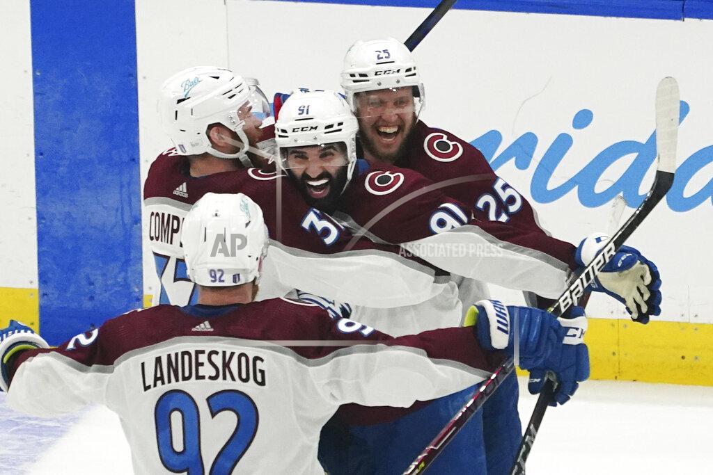 John Bazemore Colorado Avalanche center Nazem Kadri (91) is congratulated by teammates after his overtime goal on Tampa Bay Lightning goaltender Andrei Vasilevskiy (88) in Game 4 of the NHL hockey Stanley Cup Finals on Wednesday, June 22, 2022, in Tampa, Fla. (AP Photo/John Bazemore)