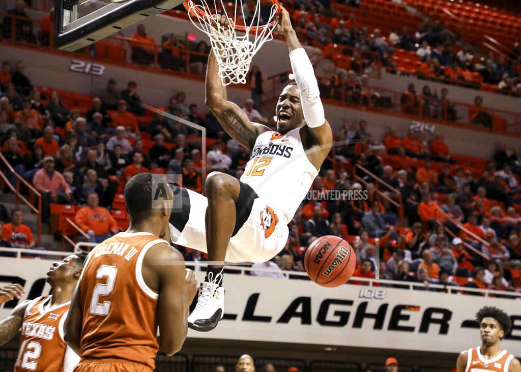 Evan Brown Oklahoma State's Cameron McGriff dunks in front of Texas' Matt Coleman III during the first half of an NCAA college basketball game Tuesday, Jan. 8, 2019, in Stillwater, Okla. (Evan Brown/Tulsa World via AP)