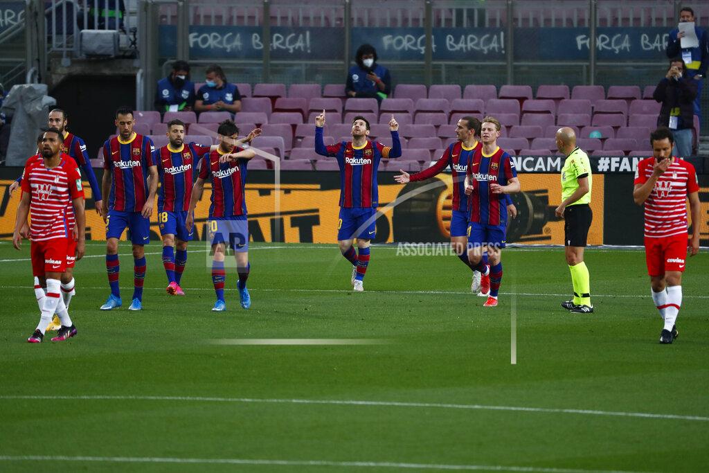 Barcelona's Lionel Messi, center, celebrates with his teammates after scoring his side's opening goal during the Spanish La Liga soccer match between FC Barcelona and Granada at the Camp Nou stadium in Barcelona, Spain, Thursday, April 29, 2021. (AP Photo/Joan Monfort)