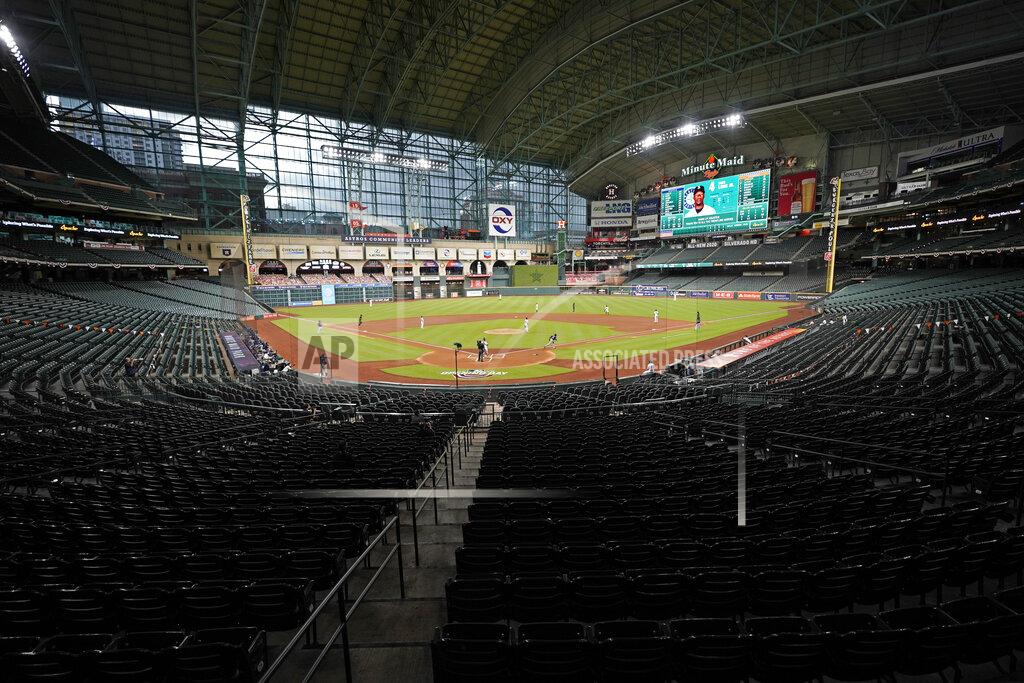 David J. Phillip The Seattle Mariners play the Houston Astros in an empty Minute Maid Park during the first inning of a baseball game Friday, July 24, 2020, in Houston. (AP Photo/David J. Phillip)