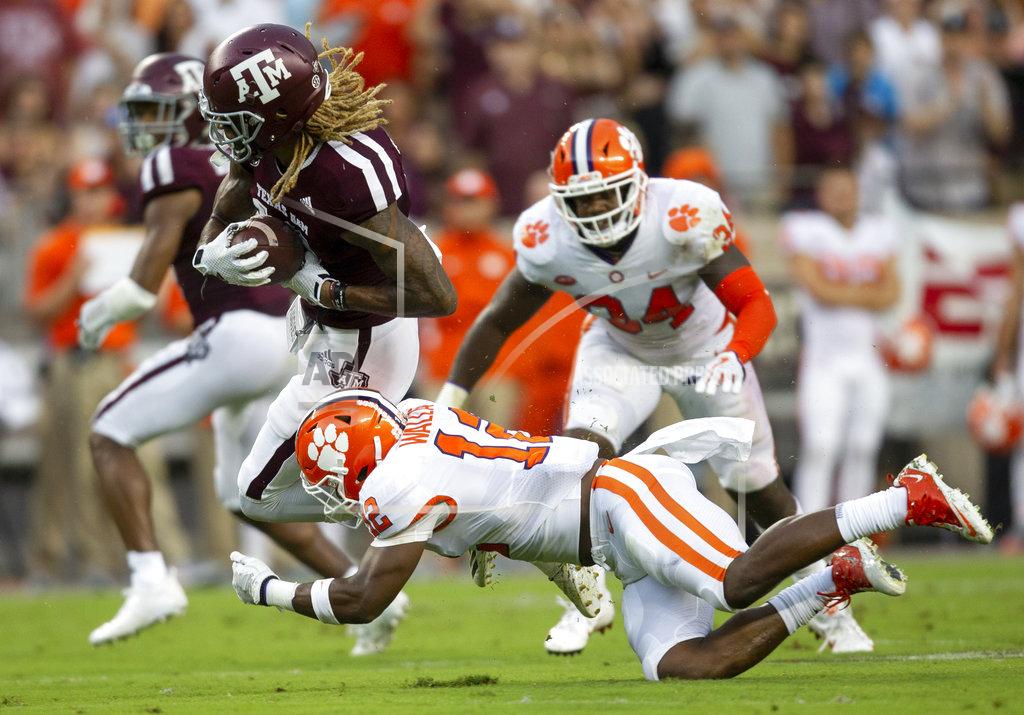 FILE - In this Saturday, Sept. 8, 2018, file photo, Texas A&M wide receiver Kendrick Rogers (13) breaks a tackle by Clemson defensive back K'Von Wallace (12) after a reception in the first half of an NCAA college football game, in College Station, Texas. The Tigers have questions to answer about their dominant defense, which gave up 501 yards and three second-half touchdowns in Texas A&M's rally in a 28-26 loss. (AP Photo/Sam Craft, File)