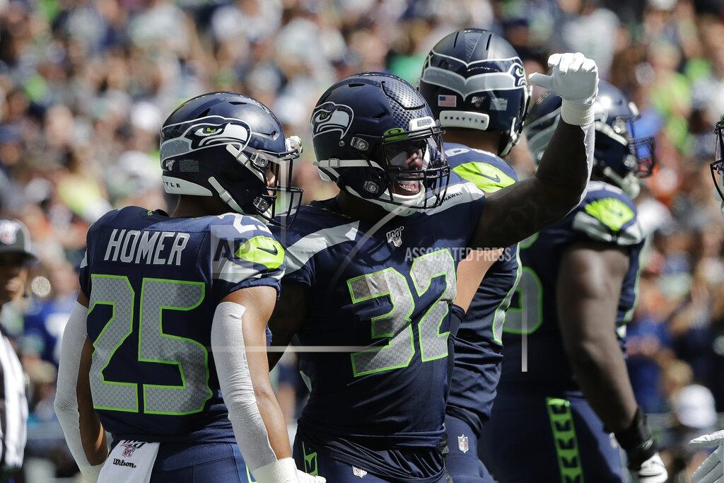 John Froschauer Seattle Seahawks running back Chris Carson (32) celebrates with running back Travis Homer (25) after Carson scored a touchdown during the first half of an NFL football game, Sunday, Sept. 8, 2019, in Seattle. (AP Photo/John Froschauer)