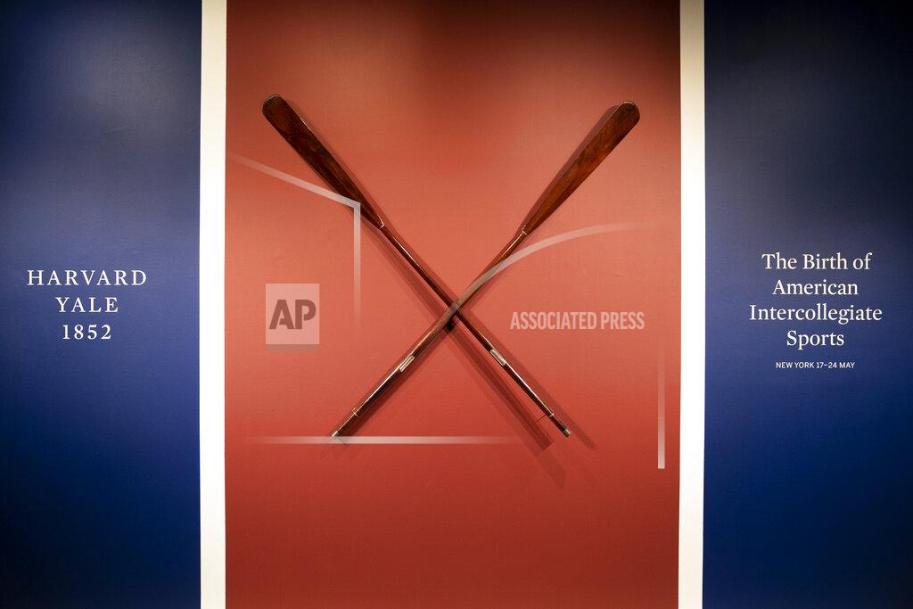 John Minchillo The Harvard-Yale Regatta 1852 Trophy Oars are displayed before an auction, Thursday, April 21, 2022, at Sotheby's in the Manhattan borough of New York. Sotheby's estimates the oars value between three and five million dollars. The oars were awarded to Harvard's winning crew and represent one of the oldest collegiate athletic competitions in the nation's history. (AP Photo/John Minchillo)