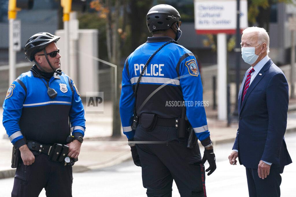 Carolyn Kaster FILE - In this Oct. 19, 2020 file photo, then Democratic presidential candidate former Vice President Joe Biden talks with Wilmington, Del., police officers as he departs The Queen theatre in Wilmington, Del. Local government leaders are trying again to secure billions of dollars in federal aid as they cobble together city budgets amid the economic uncertainty of the pandemic. But their quest for about $140 billion is subject to intense partisan wrangling over President Joe Biden's $1.9 trillion proposed response to COVID-19. (AP Photo/Carolyn Kaster)