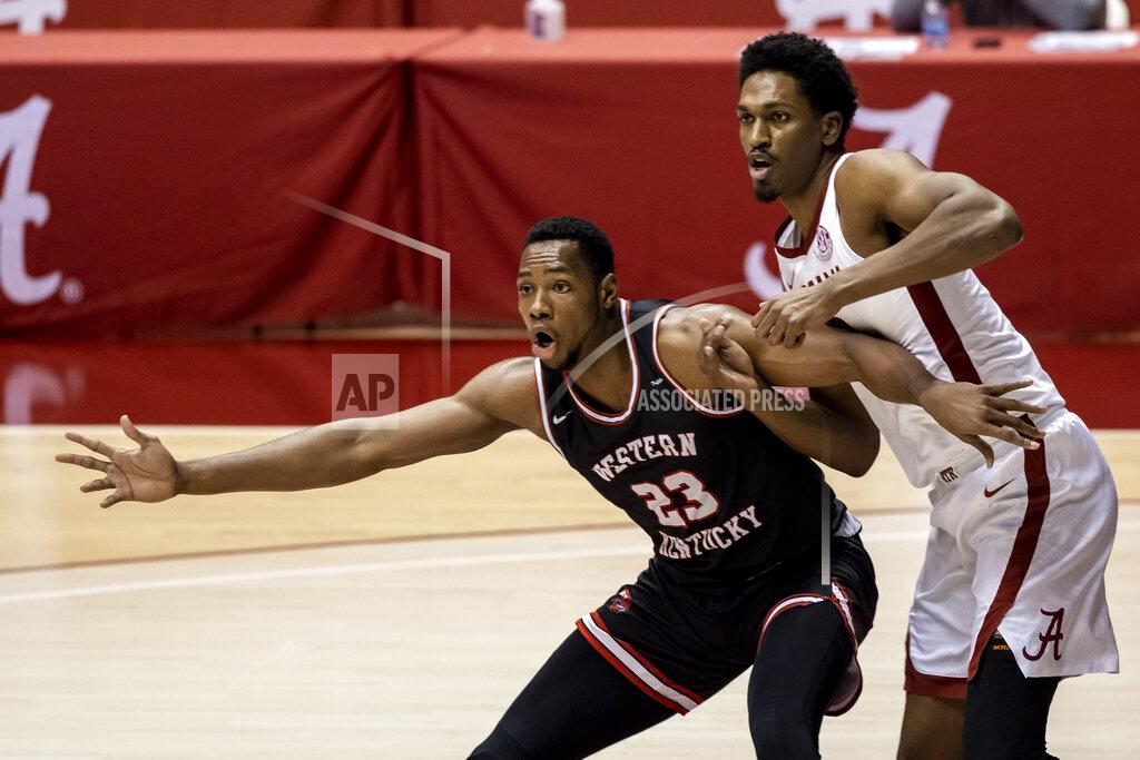 Vasha Hunt Western Kentucky center Charles Bassey (23) and Alabama guard Joshua Primo (11) battle under the basket during the first half of an NCAA college basketball game, Saturday, Dec. 19, 2020, in Tuscaloosa, Ala. (AP Photo/Vasha Hunt)