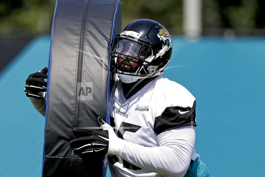 John Raoux FILE - In this June 4, 2018, file photo, Jacksonville Jaguars defensive tackle Abry Jones performs a drill during an NFL football practice in Jacksonville, Fla. As the league celebrates its 100th season, it continues to expand its foreign footprint with five international games in 2019. Abry Jones has made six trips to London in as many seasons. (AP Photo/John Raoux, File)