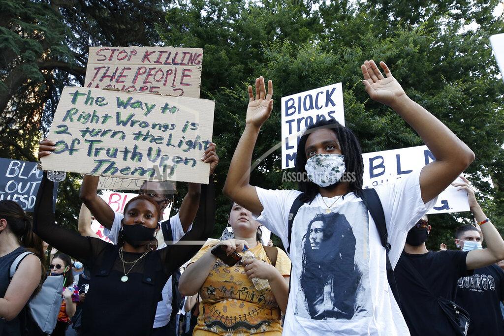 Rich Pedroncelli Demonstrators hold up their hands during a rally in Sacramento, Calif., Tuesday, June 2, 2020, protesting the death of George Floyd. Floyd died May 25 after being restrained by Minneapolis police. (AP Photo/Rich Pedroncelli)