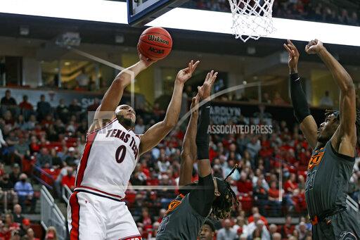 Texas Tech's Kevin Obanor (0) shoots the ball around Oklahoma State's Keylan Boone (20) during the first half of an NCAA college basketball game on Thursday, Jan. 13, 2022, in Lubbock, Texas. (AP Photo/Brad Tollefson)