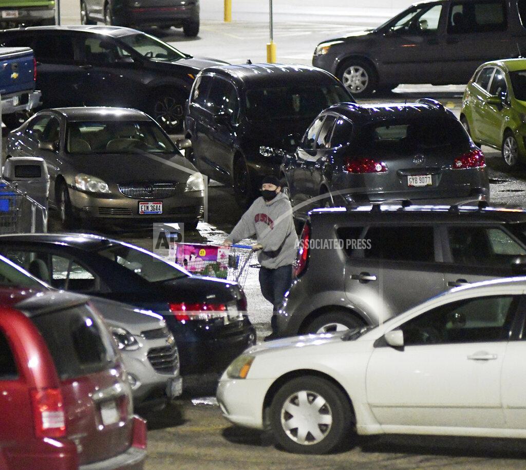 Warren Dillaway A Black Friday shopper negotiates the Walmart parking lot early Friday, Nov. 27, 2020, in Ashtabula Township, Ohio. (Warren Dillaway/The Star-Beacon via AP)