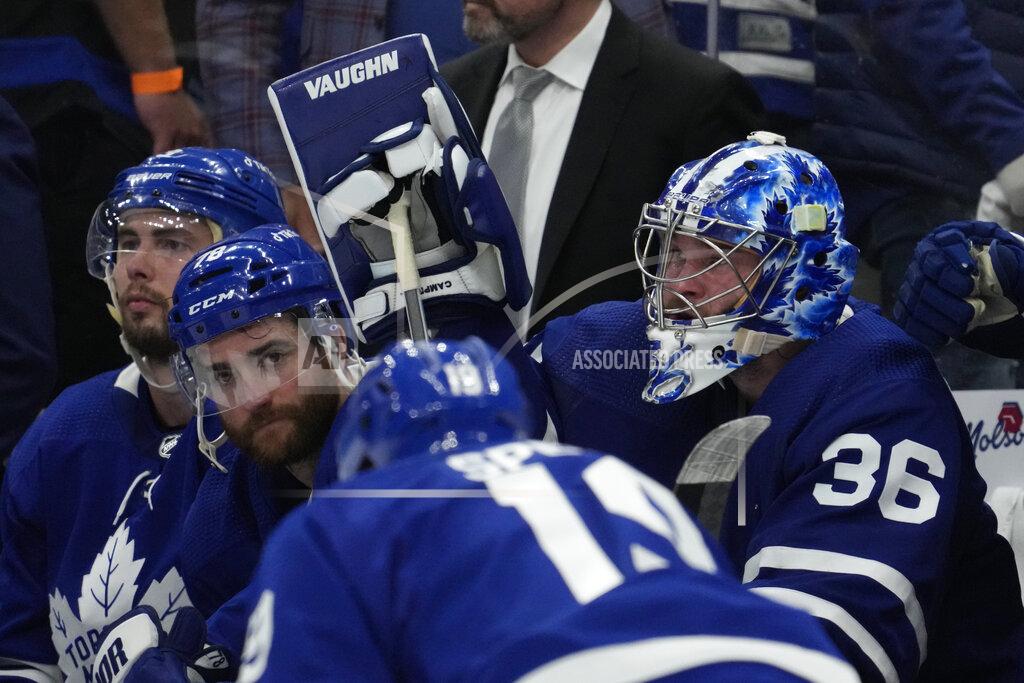 Frank Gunn Toronto Maple Leafs goaltender Jack Campbell (36) and teammates TJ Brodie, center, and Justin Holl, left, react after Game 7 of an NHL hockey first-round playoff series against hte Tampa Bay Lightning in Toronto, Saturday, May 14, 2022. (Frank Gunn/The Canadian Press via AP)