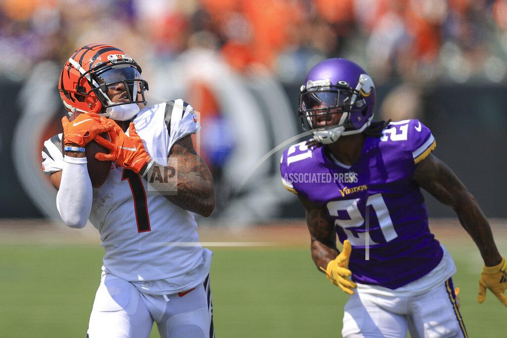 Cincinnati Bengals wide receiver Ja'Marr Chase (1) makes a catch past Minnesota Vikings defensive back Bashaud Breeland (21) and takes it in for a touchdown in the first half of an NFL football game, Sunday, Sept. 12, 2021, in Cincinnati. (AP Photo/Aaron Doster)