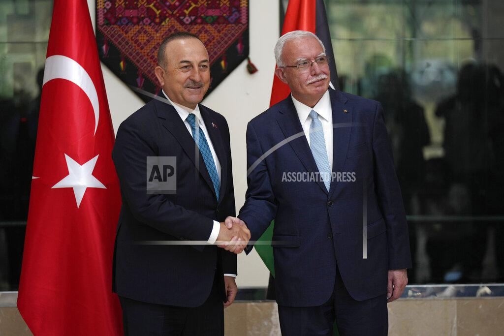 Majdi Mohammed Turkish Foreign Minister Mevlut Cavusoglu, left, shares hands with Palestinian Foreign Minister Riad al-Malki, in the West Bank town of Ramallah,, Tuesday, May 24, 2022. (AP Photo/Majdi Mohammed)