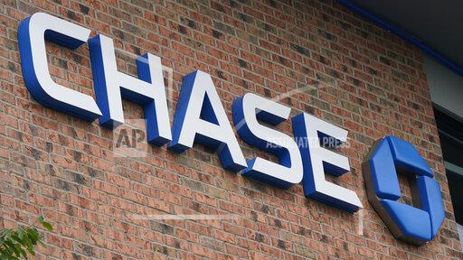 A Chase bank sign is shown in Richmond, Va., Wednesday, June 2, 2021. JPMorgan Chase’s said, Friday, Jan. 14, 2022 its fourth quarter profits fell 14% from a year earlier, as the company saw a weaker performance out of its trading desk and had higher compensation expenses for its employees. (AP Photo/Steve Helber)