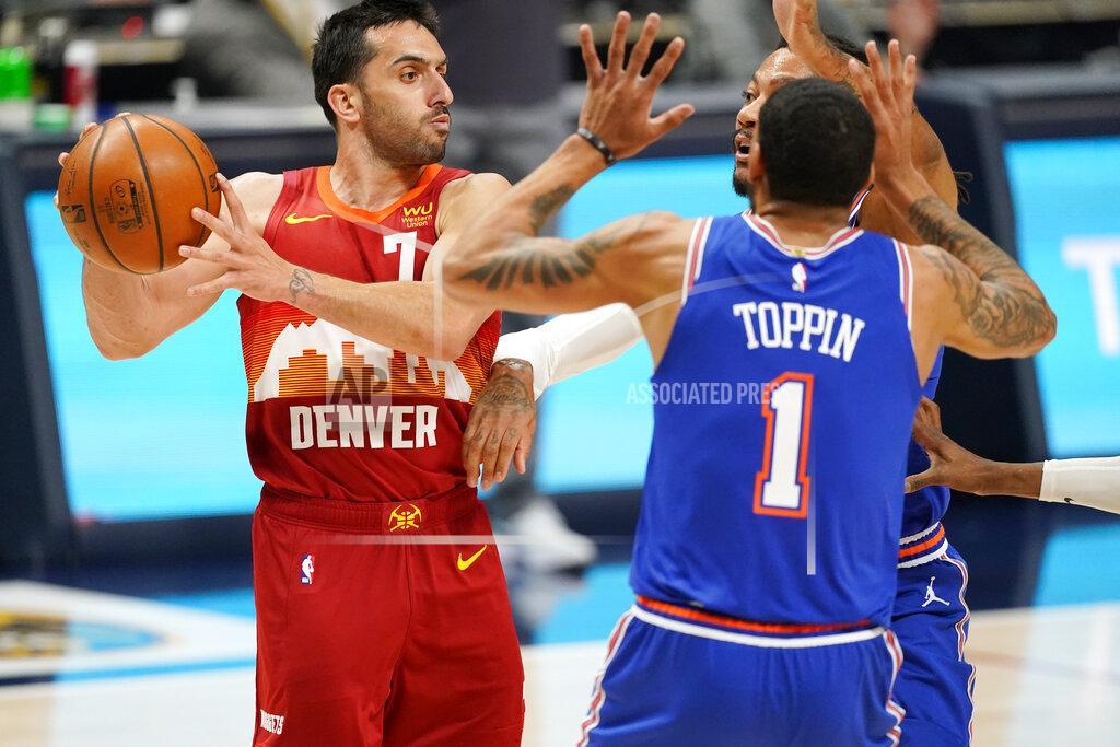 David Zalubowski Denver Nuggets guard Facundo Campazzo, left, looks to pass the ball as New York Knicks forward Obi Toppin, front right, and guard Derrick Rose defend in the first half of an NBA basketball game Wednesday, May 5, 2021, in Denver. (AP Photo/David Zalubowski)