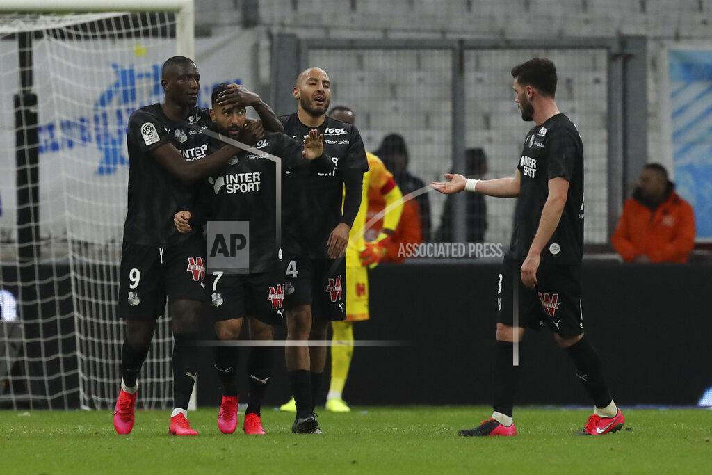 Daniel Cole Amiens' Saman Ghoddos, second left, celebrates with teammates Serhou Guirassy, left, and Haitam Aleesami, second right, after scoring his side's second goal during the French League One soccer match between Marseille and Amiens at the Velodrome stadium in Marseille, southern France, Friday, March 6, 2020. Ghoddos and Guirassy scored once each and the match ended in a 2-2 draw. (AP Photo/Daniel Cole)
