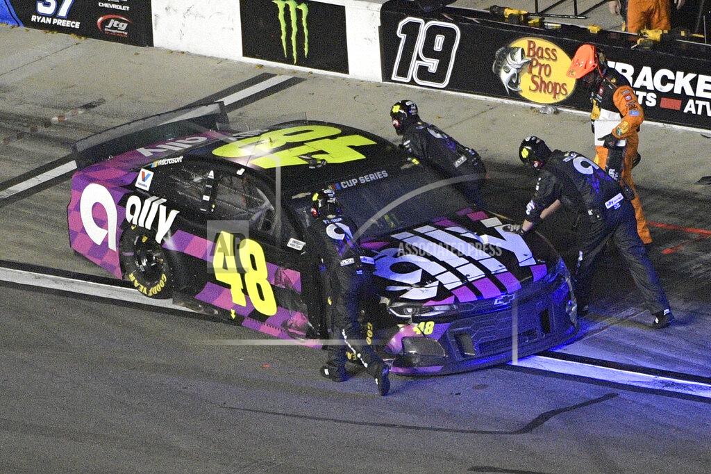 Crew members push Jimmie Johnson (48) back to the garage area during the NASCAR Daytona 500 auto race at Daytona International Speedway, Monday, Feb. 17, 2020, in Daytona Beach, Fla. (AP Photo/Phelan M. Ebenhack)