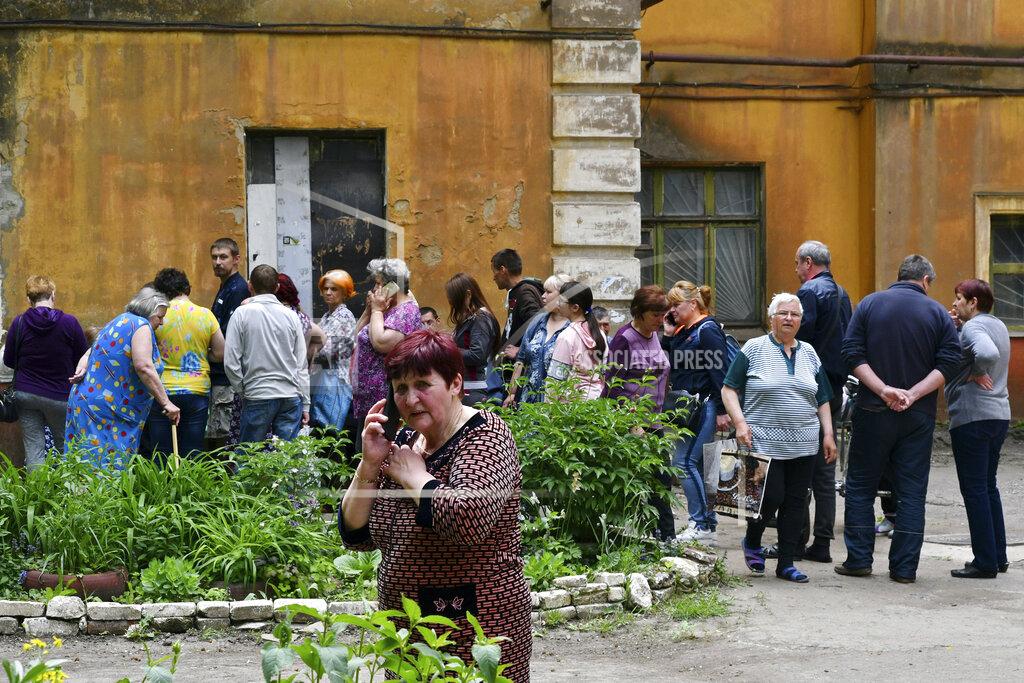 Andriy Andriyenko People wait to receive humanitarian aid in Kramatorsk, Ukraine, Saturday, May 28, 2022. (AP Photo/Andriy Andriyenko)