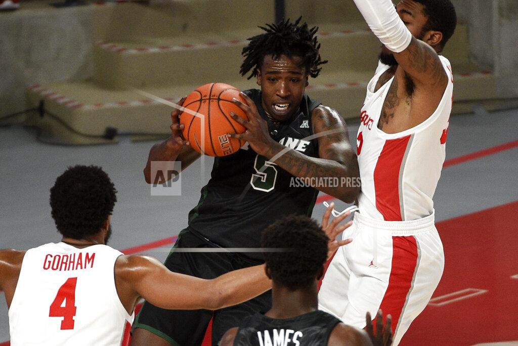 Eric Christian Smith Tulane forward Kevin Cross (5) looks to pass as Houston forward Reggie Chaney, right, and Justin Gorham (4) defend during the first half of an NCAA college basketball game, Saturday, Jan. 9, 2021, in Houston. (AP Photo/Eric Christian Smith)