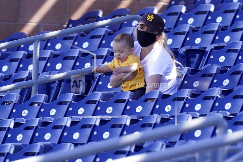 Charlie Riedel A San Diego Padres fan watches the second inning of a spring training baseball game against the Chicago Cubs, Monday, March 1, 2021, in Peoria, Ariz. (AP Photo/Charlie Riedel)