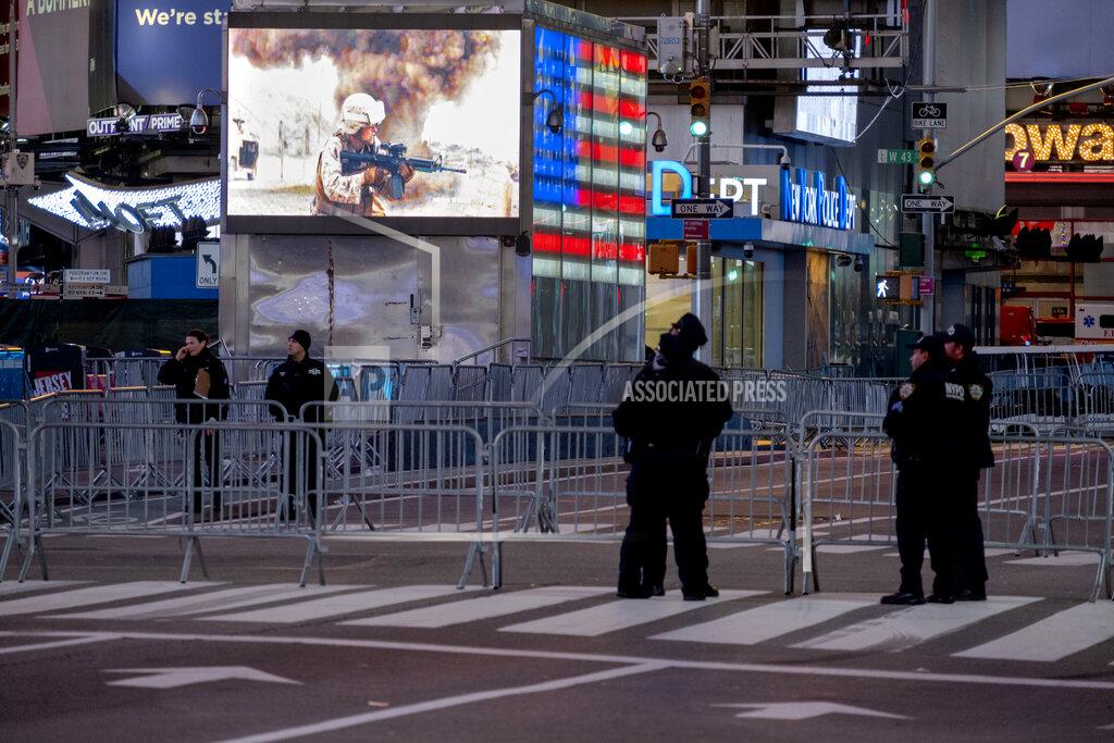 Craig Ruttle Police officers stand along a mostly empty Seventh Avenue during what would normally be a Times Square packed with people in New York, late Thursday, Dec. 31, 2020, as celebrations have been truncated this New Year's Eve due to the ongoing pandemic. (AP Photo/Craig Ruttle)