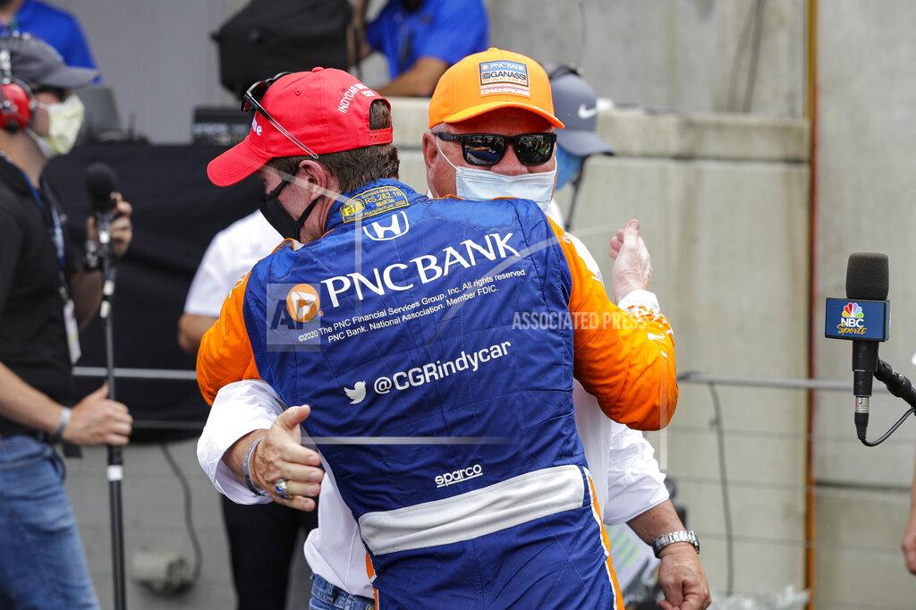 Darron Cummings Race driver Scott Dixon, of New Zealand, hugs car owner Chip Ganassi after winning the IndyCar auto race at Indianapolis Motor Speedway in Indianapolis, Saturday, July 4, 2020. (AP Photo/Darron Cummings)