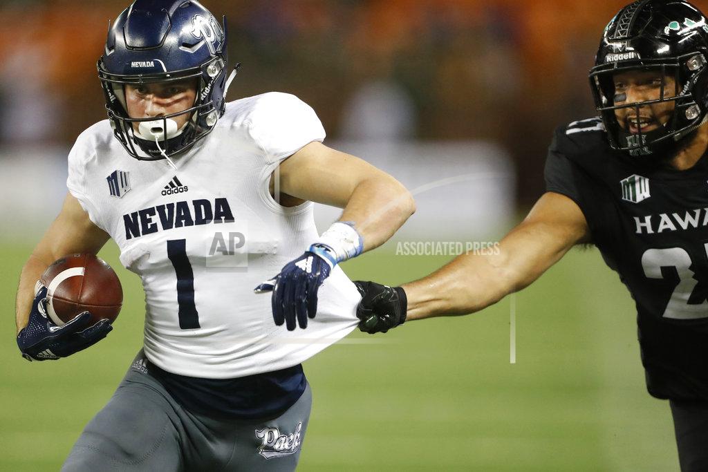 Marco Garcia Hawaii linebacker Solomon Matautia (27) tries to pull down Nevada wide receiver McLane Mannix (1) during the third quarter at an NCAA college football game Saturday, Oct. 20, 2018, in Honolulu. The play was called back due to an offensive foul. (AP Photo/Marco Garcia)