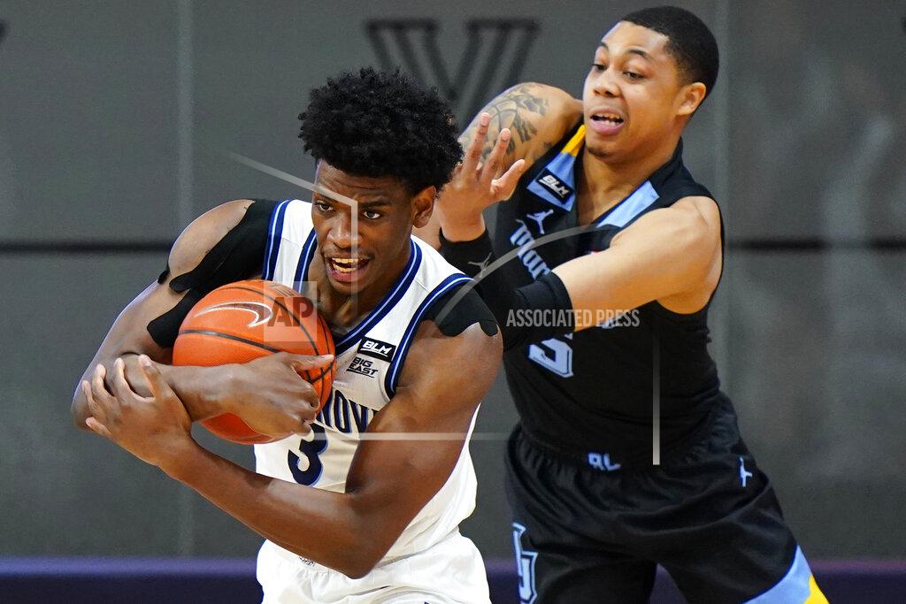 Matt Slocum Villanova's Brandon Slater, left, tries to hang onto the ball against Marquette's Greg Elliott during the second half of an NCAA college basketball game, Wednesday, Feb. 10, 2021, in Villanova, Pa. (AP Photo/Matt Slocum)