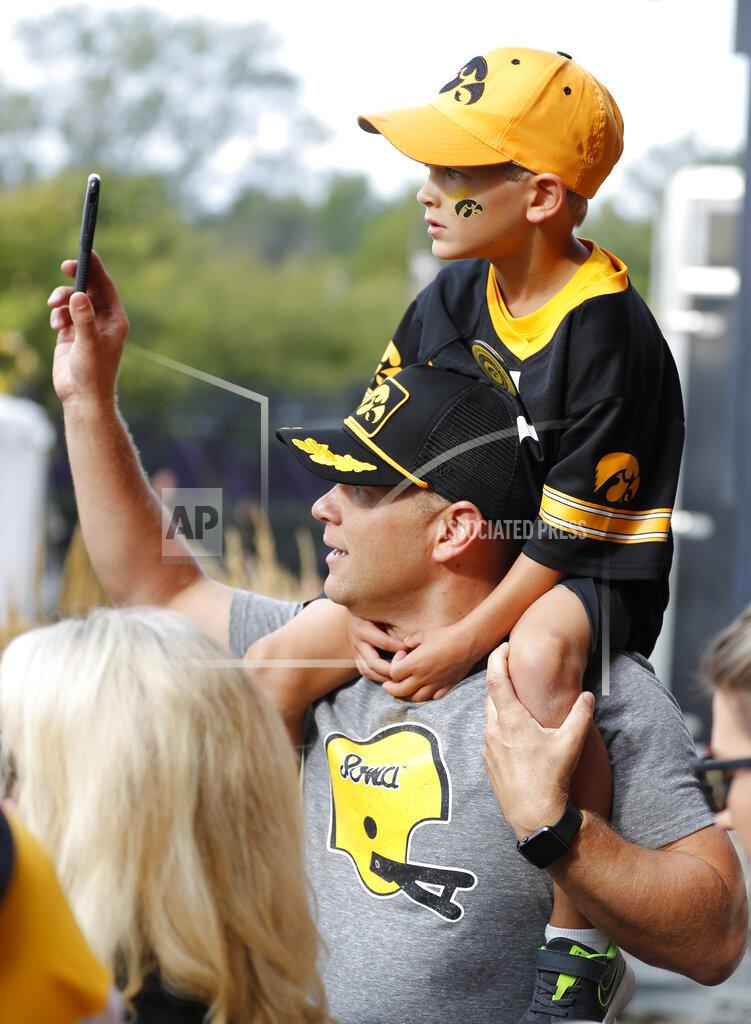 Matthew Putney Iowa fans watche as the Hawkeyes arrive at Kinnick Stadium before the team's NCAA college football game against Rutgers, Saturday, Sept. 7, 2019, in Iowa City. (AP Photo/Matthew Putney)