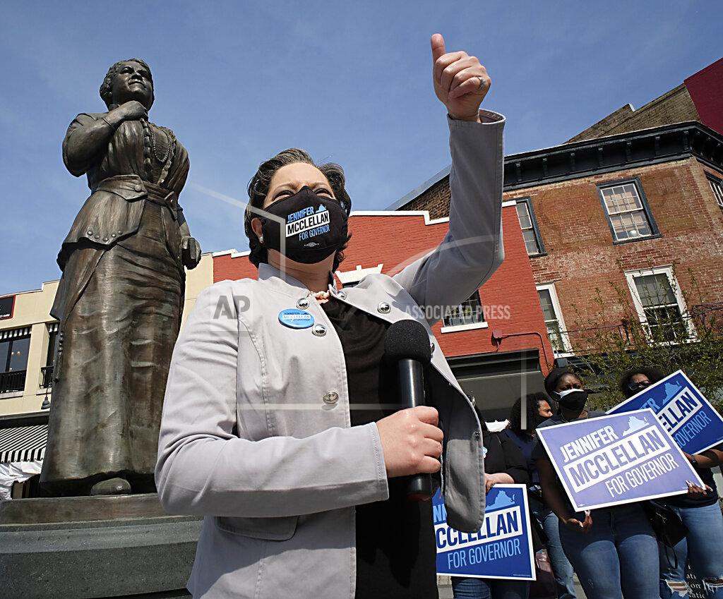 Bob Brown Sen. Jennifer McClellan, D-Richmond, gives a thumbs-up to a passing motorist who blew the horn as she was holding a press conference to discuss her gubernatorial campaign beneath the Maggie L. Walker statue in Richmond, Va., Thursday, April 8, 2021. (Bob Brown/Richmond Times-Dispatch via AP)