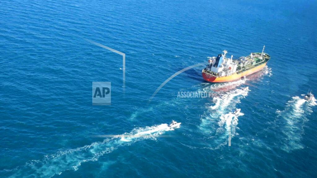 Uncredited In this photo released Monday, Jan. 4, 2021, by Tasnim News Agency, the MT Hankuk Chemi, a South Korean-flagged tanker is escorted by Iranian Revolutionary Guard boats on the Persian Gulf. Iranian state television acknowledged that Tehran seized the oil tanker in the Strait of Hormuz. The report on Monday alleged the MT Hankuk Chemi had been stopped by Iranian authorities over alleged “oil pollution” in the Persian Gulf and the strait. (Tasnim News Agency via AP)