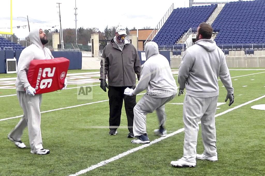 In this image provided by WaV Sports & Entertainment + The NFL Alumni Academy, Mike Tice, second from left, coaches at the NFL Alumni Academy at Tom Benson Stadium in Canton, Ohio on Nov. 4, 2020. In normal times, NFL teams sometimes must scramble to find players during the season when a wave of injuries or other issues hit. In 2020, multiply those needs exponentially because of the coronavirus pandemic. Helping out the 32 teams on a limited scale, for now, is the NFL Alumni Academy. (Devon Dalton/WaV Sports & Entertainment + The NFL Alumni Academy via AP)