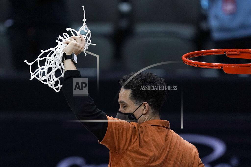 Charlie Riedel Texas head coach Shaka Smart cuts down the net after winning the Big 12 Tournament Championship NCAA college basketball game against Oklahoma State in Kansas City, Mo, Saturday, March 13, 2021. (AP Photo/Charlie Riedel)