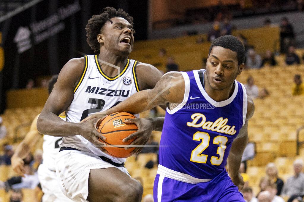 L.g. Patterson Paul Quinn's Bruce Scott, right, fouls Missouri's Kobe Brown, left, as he shoots during the second half of an NCAA college basketball game Monday, Nov. 29, 2021, in Columbia, Mo. Missouri won 91-59. (AP Photo/L.G. Patterson)