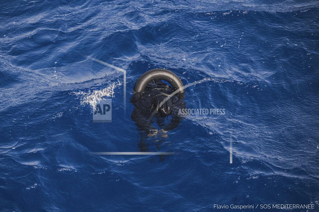 Flavio Gasperini EDS NOTE: GRAPHIC CONTENT - The body of one of the victims of the shipwreck of a dinghy which was supposedly carrying over 100 migrants, is seen floating in the Mediterranean Sea northeast of the Libyan capital, Tripoli, Thursday, April 22, 2021. When more than 100 Africans hoping to reach Europe on a rubber boat called repeatedly for help in late April, a rescue never came. In all, approximately 130 people are believed to have died off the Libyan coast. It was the deadliest wreck so far this year in the Mediterranean Sea and has renewed accusations that European countries are failing to help migrant boats in trouble. (Flavio Gasperini/SOS Mediterranee via AP)