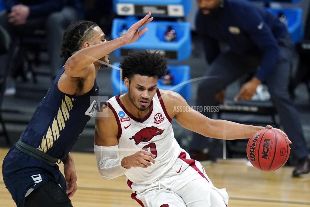 Jeff Roberson Arkansas forward Justin Smith (0) drives around Oral Roberts forward Kevin Obanor, left, during the first half of a Sweet 16 game in the NCAA men's college basketball tournament at Bankers Life Fieldhouse, Saturday, March 27, 2021, in Indianapolis. (AP Photo/Jeff Roberson)