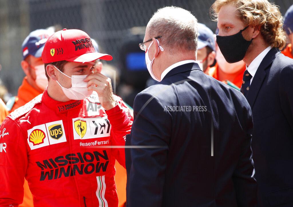 Sebastien Nogier Ferrari driver Charles Leclerc of Monaco, left, speaks with Prince Albert II of Monaco, center, prior to the start of the Monaco Grand Prix at the Monaco racetrack, in Monaco, Sunday, May 23, 2021. (Sebastien Nogier, Pool via AP)